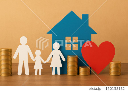 Paper cutout figures of family holding hands with blue house and red heart symbolizing home love and financial security with stacks of gold coins on wooden surface 130158182