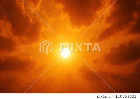 Bright golden sun shining through dramatic orange clouds with intense heatwave atmosphere and vivid sky creating powerful and warm feeling in environment 130158623