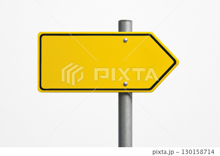 Yellow directional arrow sign on metallic pole with white background navigation and guidance concept, simple design for clear visual communication and wayfinding 130158714