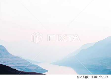 Mountain landscape at dawn with mist reflecting on calm water 130158973