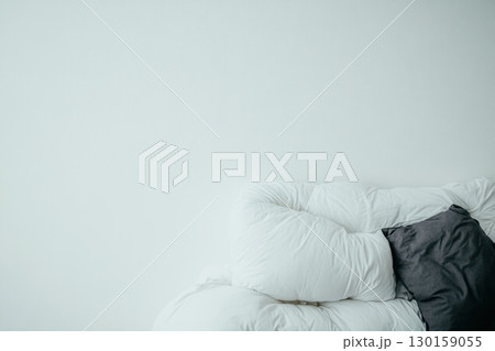 Cozy white sofa with a gray cushion in a bright, minimalistic living room 130159055