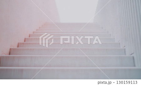 Staircase leading to bright light at the top in modern architecture Staircase leading to bright light at the top in modern architecture 130159113