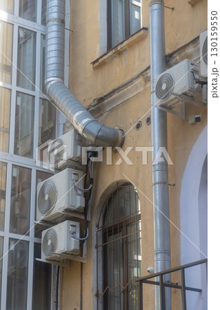 Air conditioners are installed on facade of building. device for comfortable living in hot weather. Air conditioners are installed on facade of building. device for comfortable living in hot weather. 130159550