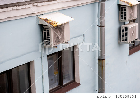air conditioners are installed on the wall of the building. cooling in hot weather. air conditioners are installed on the wall of the building. cooling in hot weather. 130159551