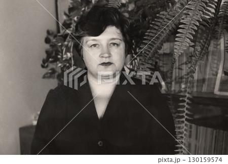 Vintage portrait of attractive middle-aged woman dressed in a strict style. Retro photo from 1984. Vintage portrait of attractive middle-aged woman dressed in a strict style. Retro photo from 1984. 130159574