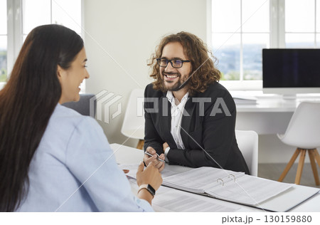 Business people at work in office. Two employers sitting at the desk on workplace and talking. 130159880