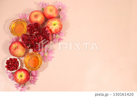 Creative composition for the Jewish holiday Ro Hashanah with a place for congratulations. Layout with traditional symbols of the Jewish New Year, template with honey, apples, pomegranate and flowers Creative composition for the Jewish holiday Ro Hashanah with a place for congratulations. Layout with traditional symbols of the Jewish New Year, template with honey, apples, pomegranate and flowers 130161420