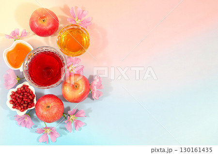 Advertising banner with symbols of the Jewish New Year, template with honey, apples, pomegranate, red wine and flowers. Creative composition for congratulations on the Jewish holiday Ro Hashanah Advertising banner with symbols of the Jewish New Year, template with honey, apples, pomegranate, red wine and flowers. Creative composition for congratulations on the Jewish holiday Ro Hashanah 130161435