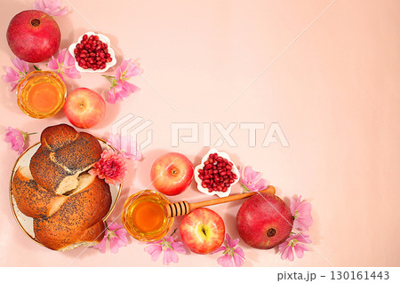 Jewish holiday Rosh Hashanah concept with apples, honey, pomegranate, flowers and Challah bread for greeting card, creative mockup and template for Jewish New Year and Thanksgiving 130161443