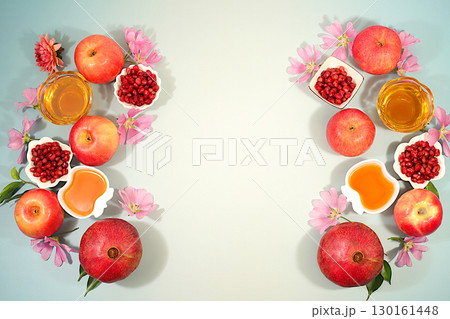 Creative composition for the Jewish holiday Ro Hashanah with a place for congratulations. Layout with traditional symbols of the Jewish New Year, template with honey, apples, pomegranate and flowers Creative composition for the Jewish holiday Ro Hashanah with a place for congratulations. Layout with traditional symbols of the Jewish New Year, template with honey, apples, pomegranate and flowers 130161448