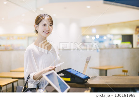 カフェのレジでキャッシュレス決済 をする女性 130161969
