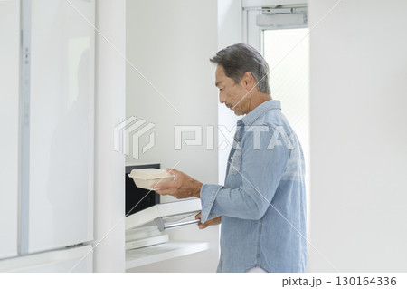 電子レンジを使うシニア男性 電子レンジを使うシニア男性 130164336