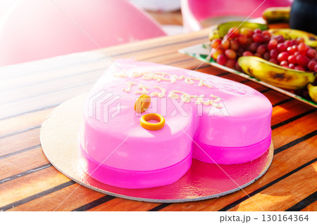 Heart-shaped pink cake with rings Heart-shaped pink cake with rings 130164364