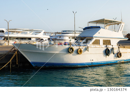 An unwashed yacht is moored in the marina 130164374