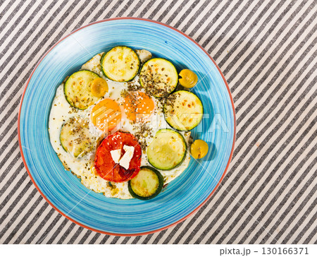Top view of fried eggs with zucchini Top view of fried eggs with zucchini 130166371