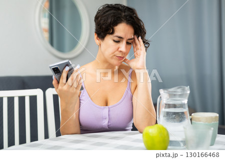 Displeased woman talking on mobile phone Displeased woman talking on mobile phone 130166468