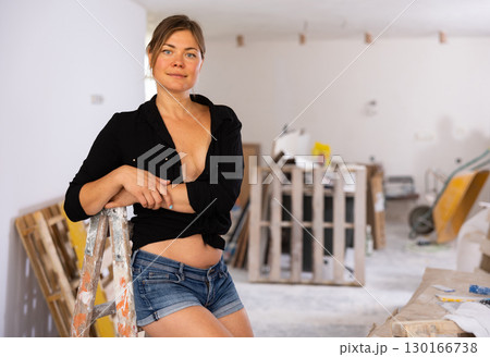 Portrait of a half-naked girl in short shorts in renovated room 130166738