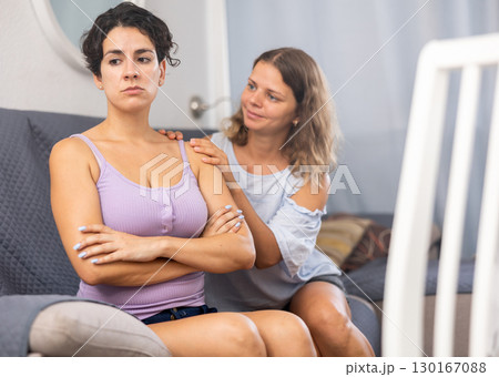 Young beautiful girl comforting her depressed girlfriend Young beautiful girl comforting her depressed girlfriend 130167088