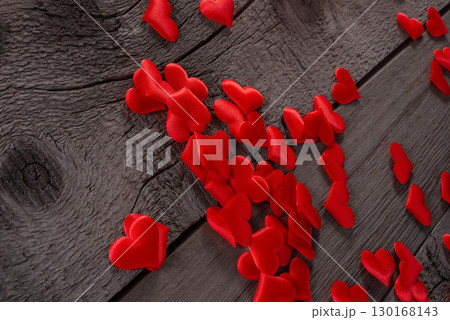 Red Fabric Hearts Scattered on Rustic Wooden Surface for Romantic Decor Theme 130168143