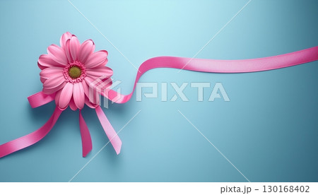 pink flower ribbon tied knot on solid blue background 130168402