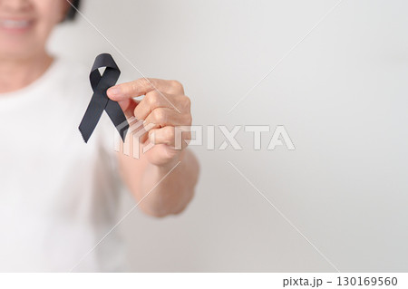 Elderly with Black ribbon for May Melanoma and skin cancer Awareness month, October Vaccine injury awareness month, Mourning Remembrance, March Sleep awareness week, Gang Prevention and Anti Violence 130169560