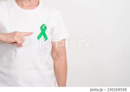 Elderly with Green Ribbon for concept of July Eye Injury Prevention month, January Glaucoma Awareness month, February Gallbladder and Bile duct and October Liver cancer. Health and world cancer day 130169588