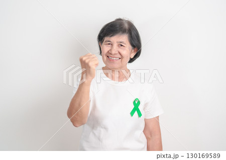 Elderly with Green Ribbon for concept of July Eye Injury Prevention month, January Glaucoma Awareness month, February Gallbladder and Bile duct and October Liver cancer. Health and world cancer day Elderly with Green Ribbon for concept of July Eye Injury Prevention month, January Glaucoma Awareness month, February Gallbladder and Bile duct and October Liver cancer. Health and world cancer day 130169589