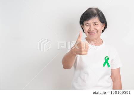 Elderly with Green Ribbon for concept of July Eye Injury Prevention month, January Glaucoma Awareness month, February Gallbladder and Bile duct and October Liver cancer. Health and world cancer day Elderly with Green Ribbon for concept of July Eye Injury Prevention month, January Glaucoma Awareness month, February Gallbladder and Bile duct and October Liver cancer. Health and world cancer day 130169591