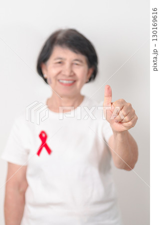 Elderly with Red Ribbon for December World Aids Day, MADD, October Red ribbon week, February Heart month, Marfan Syndrome, May Stroke awareness, March world TB Tuberculosis day and April Dare day Elderly with Red Ribbon for December World Aids Day, MADD, October Red ribbon week, February Heart month, Marfan Syndrome, May Stroke awareness, March world TB Tuberculosis day and April Dare day 130169616