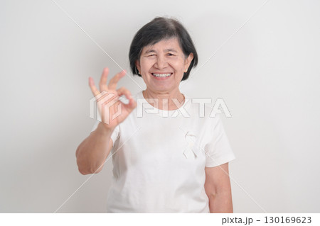 Elderly with White ribbon for concept November Lung Cancer Awareness month, Stop Violence Against Women, Adoption, May Retinoblastoma, Action for Women Health, March Remembrance, October Osteoporosis 130169623
