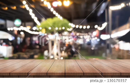 Empty wooden table top with lights bokeh on blur restaurant background. Empty wooden table top with lights bokeh on blur restaurant background. 130170357