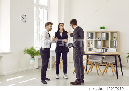 Group of business people chatting on a meeting. Company employees talking in the office. 130170504