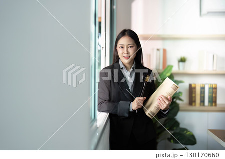 Legal Professional Holding Gavel and Case Files in Modern Office 130170660