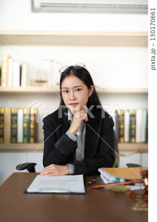 Professional Attorney. Young woman lawyer with thoughtful expression in office. 130170661