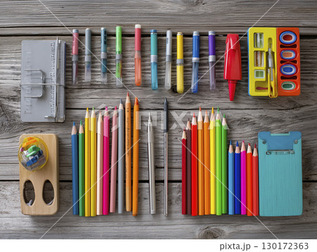 Colorful school supplies arranged on wooden desk suggest bright, organized study space, perfect for learning and creativity 130172363