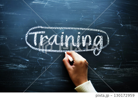Hand writing training word on black broad. 130172959