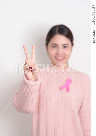 Pink October Breast Cancer Awareness month, woman with pink Ribbon for concepts of support people life and illness. National cancer survivors month, Women Health day and February World cancer day 130173337
