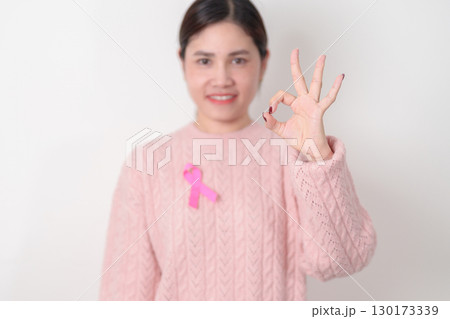 Pink October Breast Cancer Awareness month, woman with pink Ribbon for concepts of support people life and illness. National cancer survivors month, Women Health day and February World cancer day 130173339