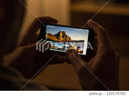 Man Browsing Travel Photography on Smartphone 130174785