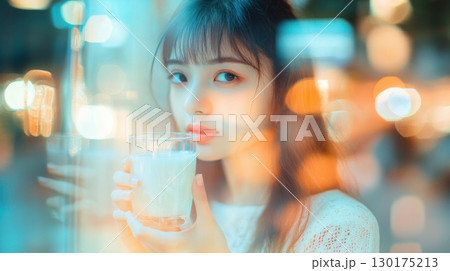 Woman Holding Glass of Milk at Night Woman Holding Glass of Milk at Night 130175213
