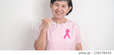 Elderly woman with pink Ribbon for Pink October Breast Cancer Awareness month, May Women Health, February World cancer day, support people life and illness. National cancer survivors month Elderly woman with pink Ribbon for Pink October Breast Cancer Awareness month, May Women Health, February World cancer day, support people life and illness. National cancer survivors month 130176910