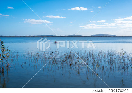 Kayaker paddling on Lake Colac, Victoria, Australia 130178269