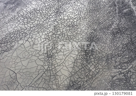 Aerial view of gray abstract mud patterns and cracks on acid mine drainage surface 130179081