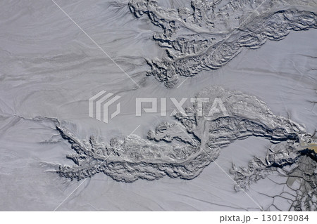 Aerial view of gray abstract mud patterns and cracks on acid mine drainage surface 130179084
