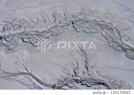 Aerial view of gray abstract mud patterns and cracks on acid mine drainage surface 130179085