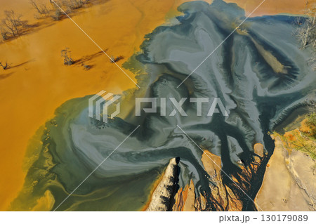 Patterns of acid mine drainage in decanting lake, nature pollution, aerial view 130179089