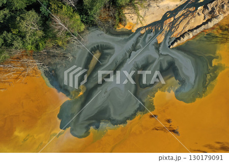 Patterns of acid mine drainage in decanting lake, nature pollution, aerial view Patterns of acid mine drainage in decanting lake, nature pollution, aerial view 130179091