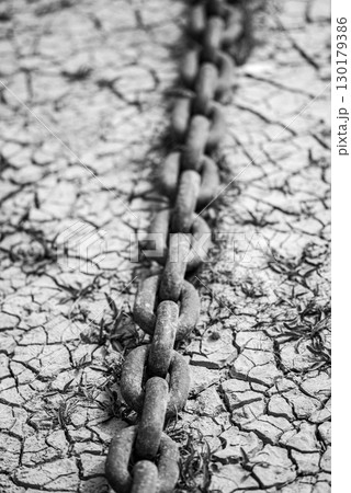 Rusty Chain on Cracked Ground in Black and White Rusty Chain on Cracked Ground in Black and White 130179386