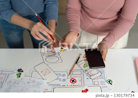 UX and UI Design Ideation. Designers creating user interface concepts with sketches. 130179734