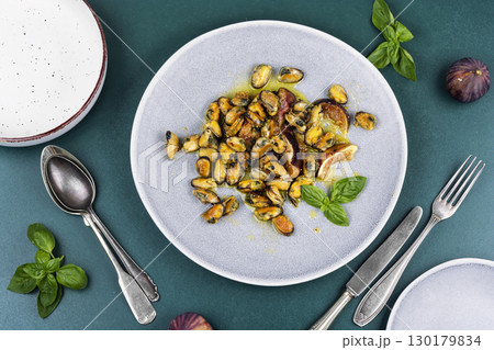 Fried seafood on a plate, mussels. 130179834